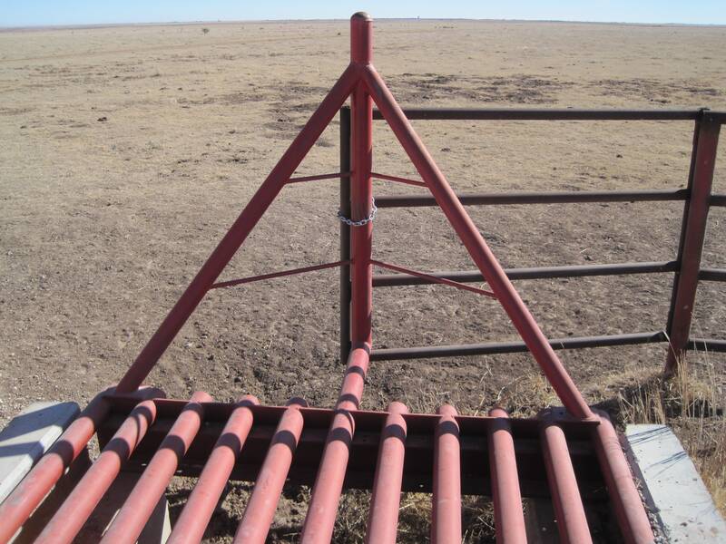 Red steel cattle guard with wing gate